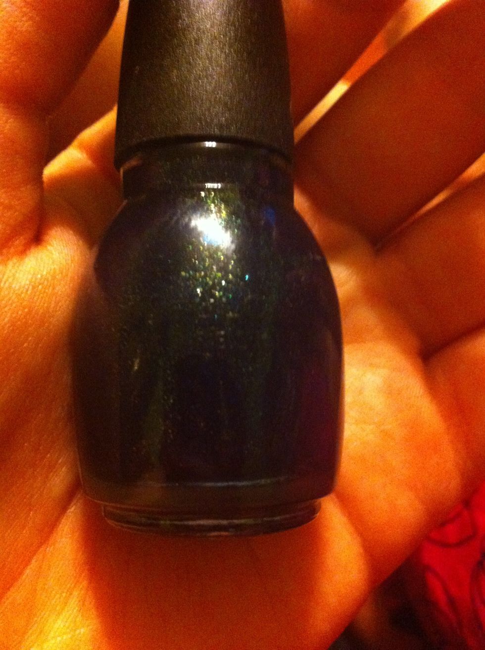 I then applied Sinful Colors in "Nova" (how appropriate!!) to my nail. It is hard to tell in this picture, but this is a navy blue color with lots of holographic sparkles.