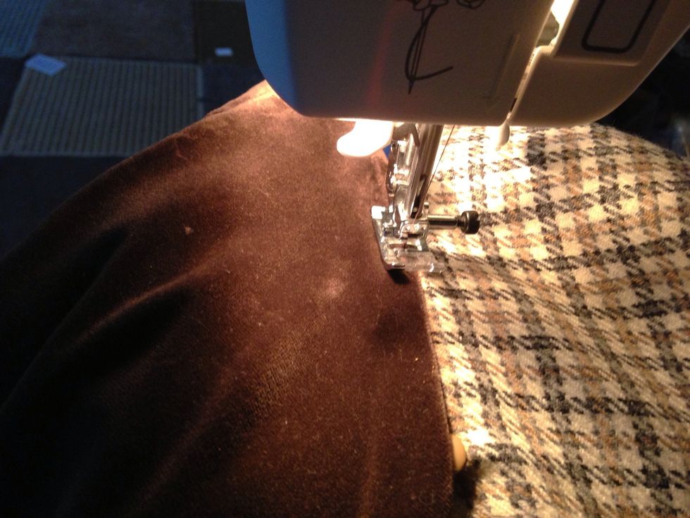 I then begin to attach the collar to the neck, I fold the fabric under as I go to ensure a neat edge then cover seam. The suede in the other side is pulled back and not sewn down at this time.