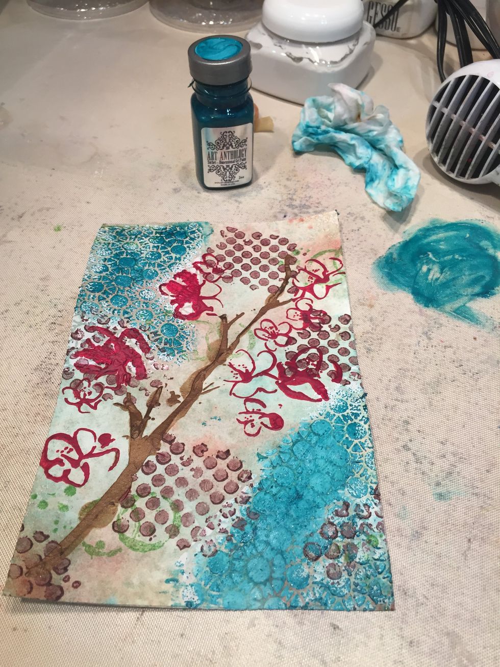 I then dipped my finger in Viridian Sorbet and rubbed it across where I had stencil with the Retro Tile stencil. I then rubbed it with a baby wipe to soften.