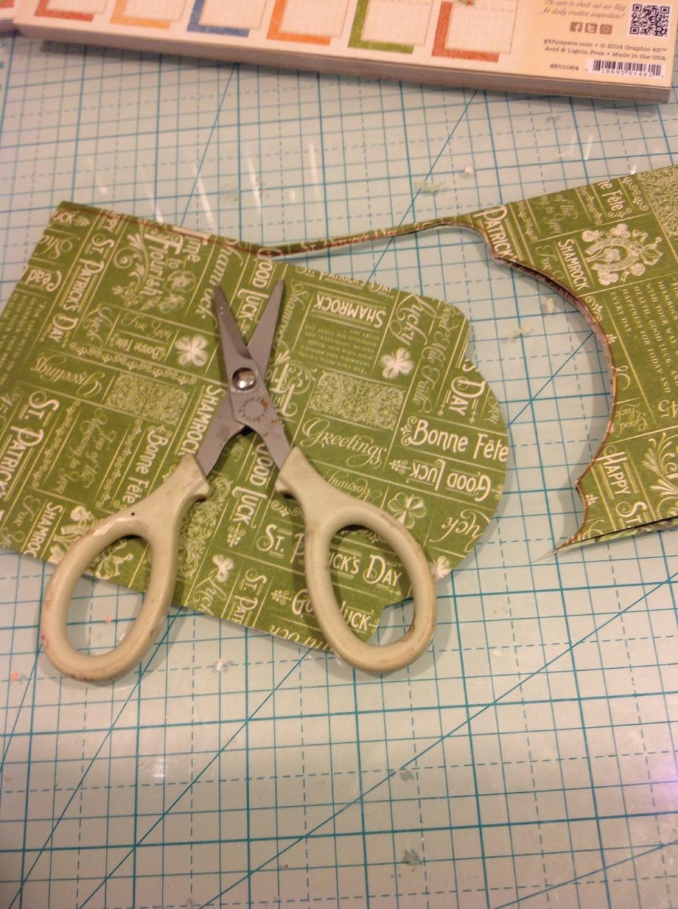 I then FOLDED a the paper in half and then cut out my shape. This cuts 2 tag shapes at the same time. And I would use the opposite design on back of the tag.