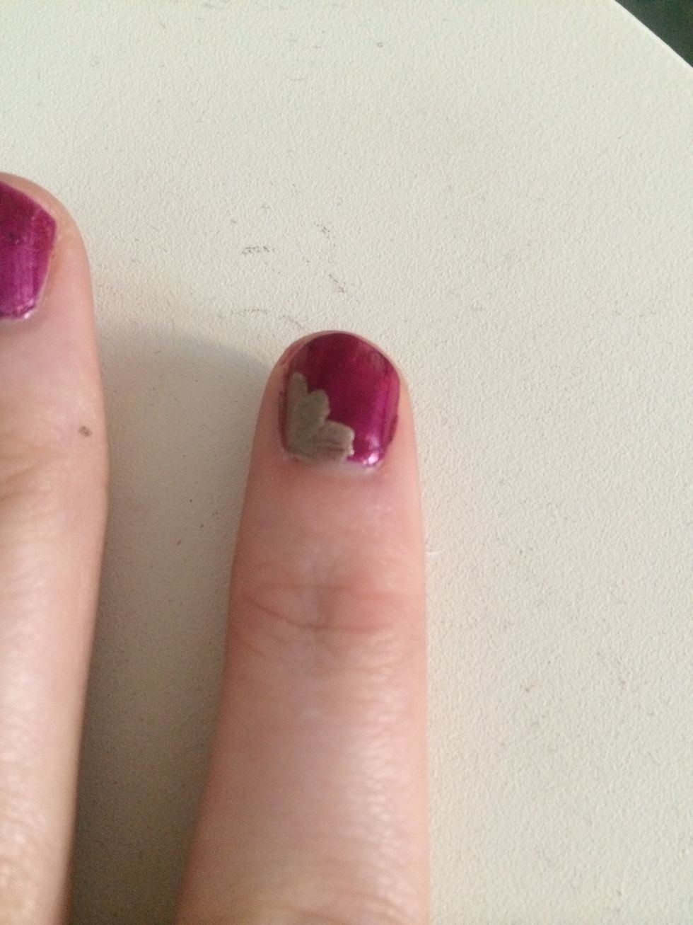 I then painted gold nail varnish on the left side, the bottom and then the middle part in between the two strokes on my nail.