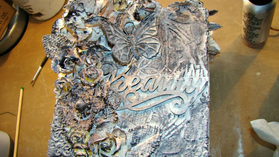 I then started adding my sprays. Starting with the darkest around the edges for shadowing. Heat set in between adding your colors so they won't blend together and you will get distinct colors.