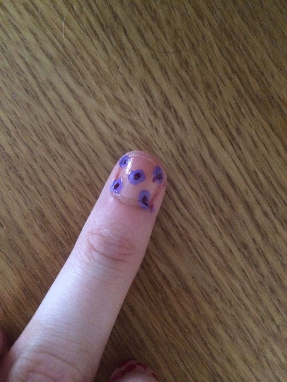 I then started by doing purple flowers. I did this by dabbing the nail brush straight onto the nail. I then used a paper clip to do the middle part of the flower.