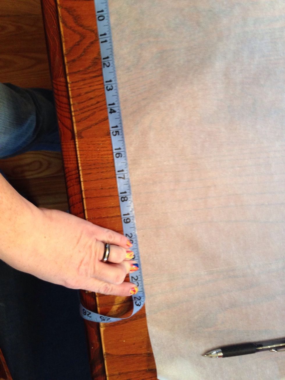 I then took my tracing paper and laid out enough to make a quarter of a circle pattern. I taped sheets together for the pattern. I measured out 22 inches and marked it on the paper.