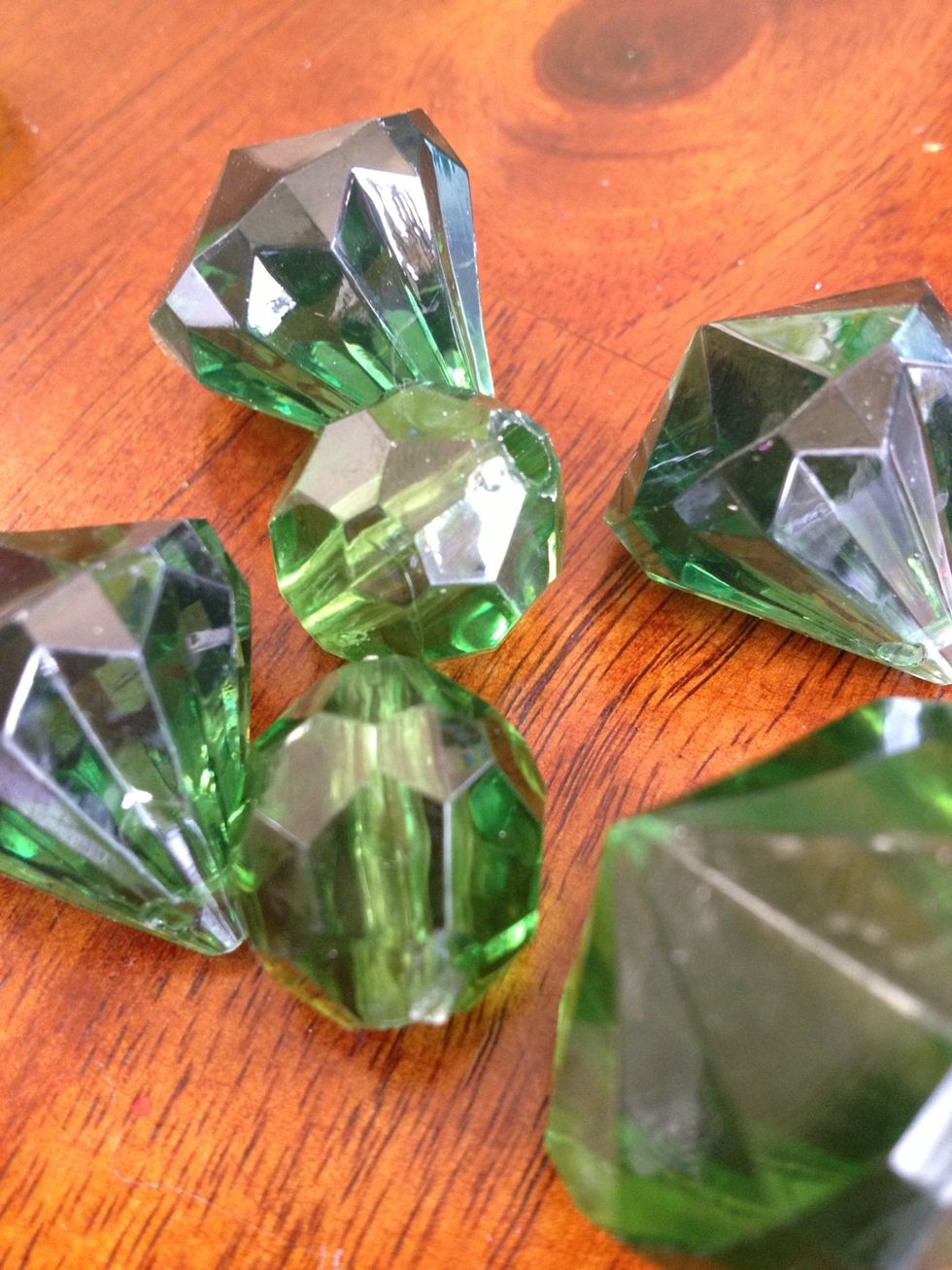 I threw 12 round plastic gems in to add a nice rattle sound and to look a little bit like bubbles in a fish tank. I also dumped in a bunch if green glitter to add sparkle.