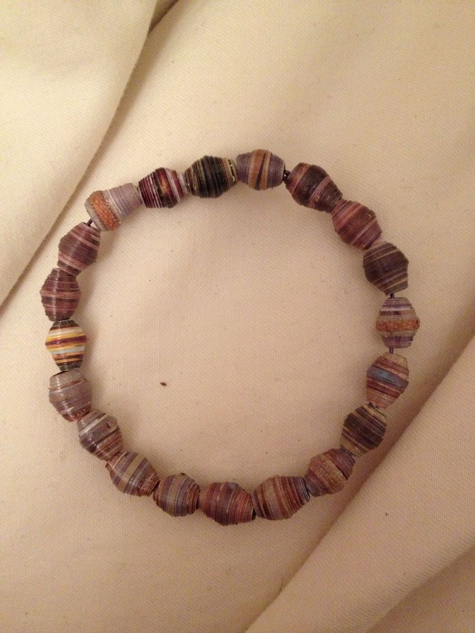 I threw some of the beads I've already made on some wire so you can get an idea of the "finished product." I'm hoping to make some paper bead jewelry as gifts for the holidays.