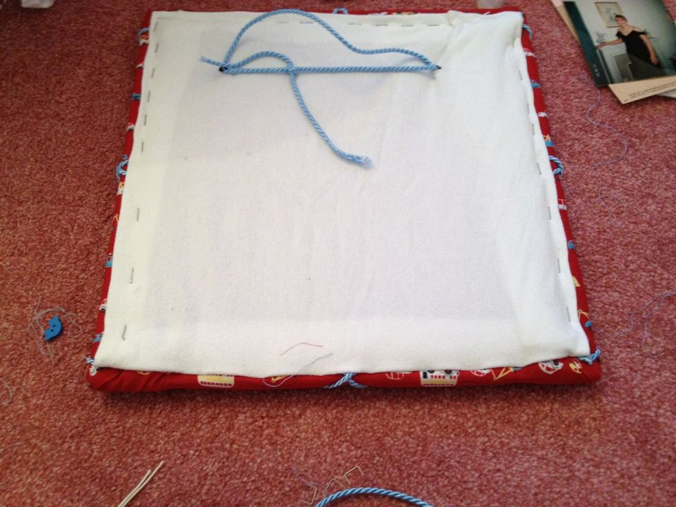 I tidied up the back of mine by covering with some white fabric . Looks neater if giving as a gift.