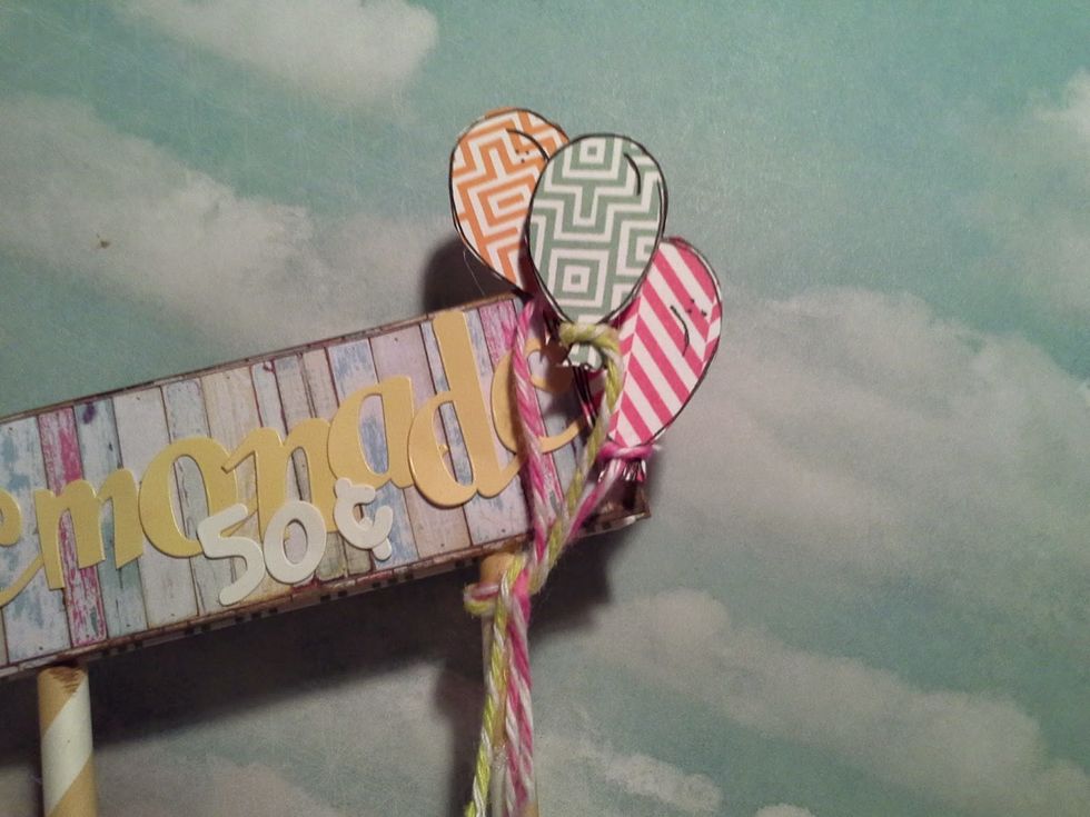 I tied some baker's twine around the balloons and then tied them to the lemonade stand as shown. after adhereing them with pop dots