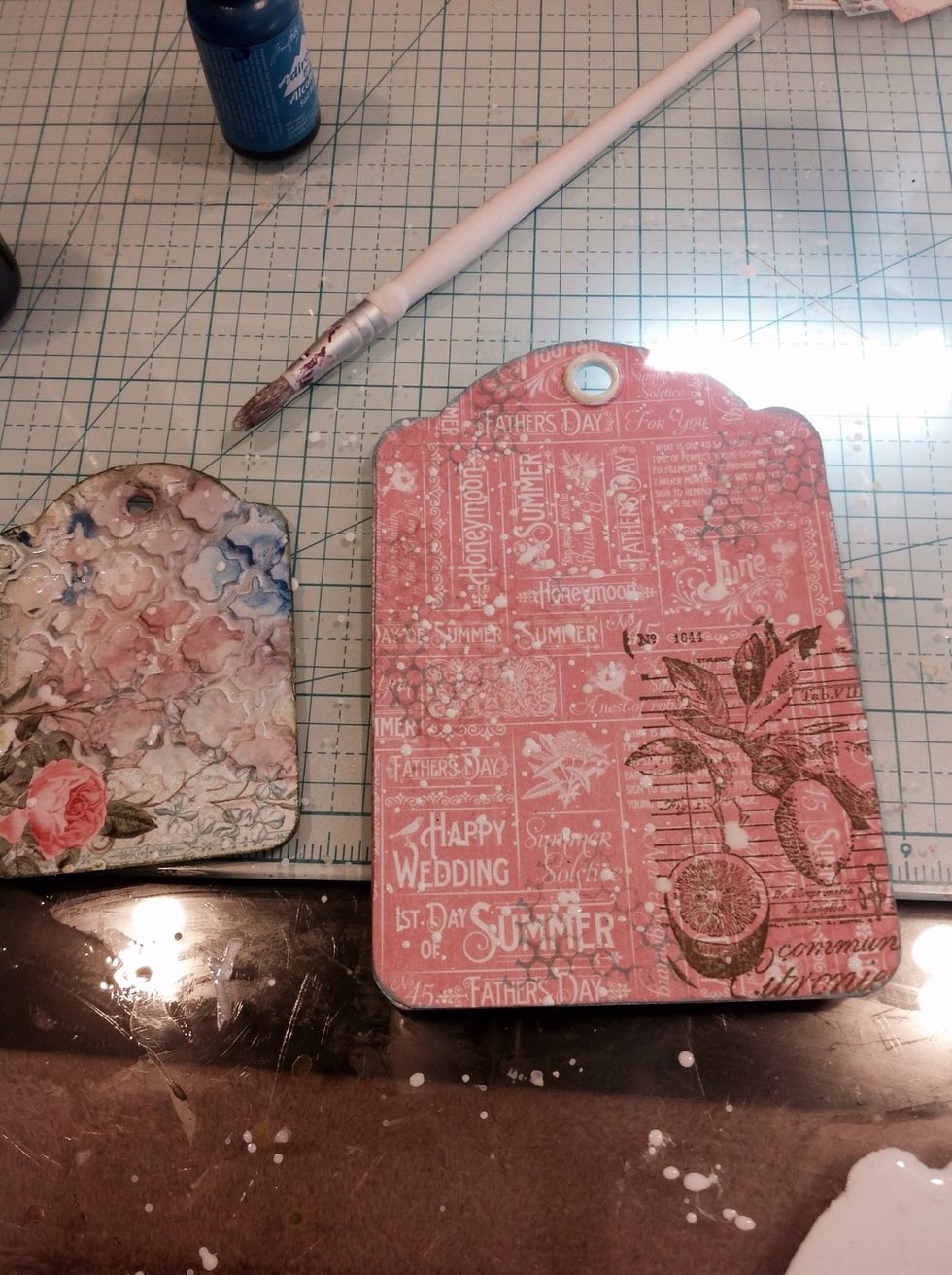 I took gesso and mixed it with water. I then dipped my paintbrush in it and flicked it all over my tags.