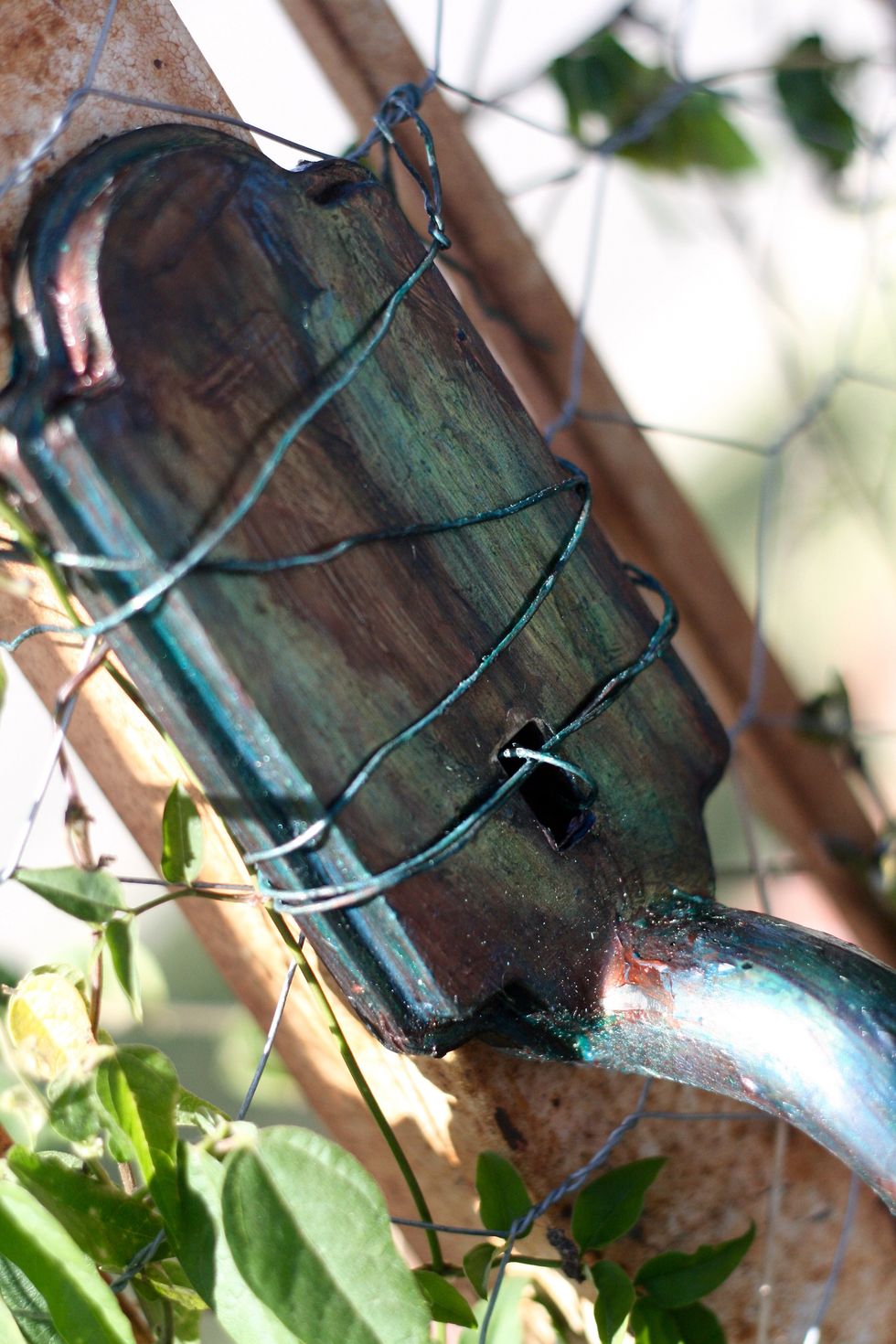 I took the patina'd wire and wrapped in through, in, out and around the handle to hold it in place on my wrought iron fence.