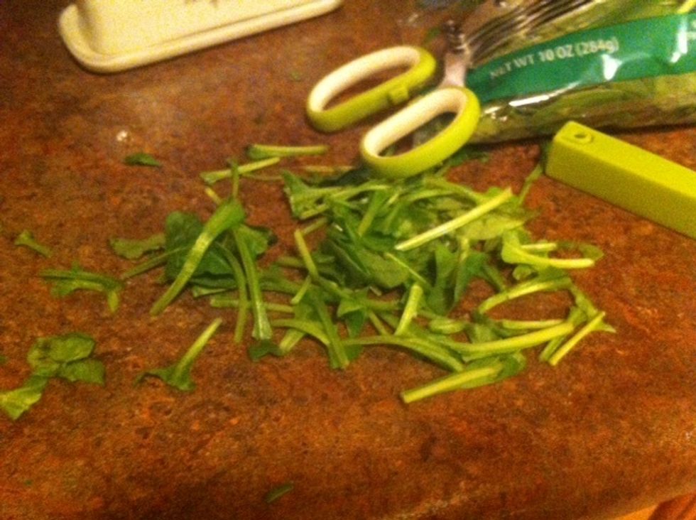 I tore them off. First muffin tin I actually used a kitchen shredding tool. Then, I just started tearing them into little pieces. 2nd muffin tin I simply laid the pieces of whole spinach in cups.