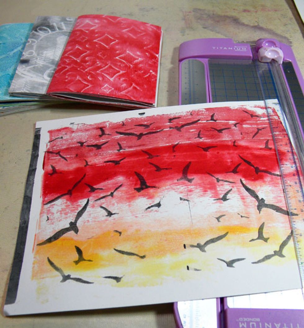 I trimmed each print down to 10" x 7" and folded them in half.  I layered the prints according to color and pattern, six prints per journal, resulting in 12 pages each when folded in half.