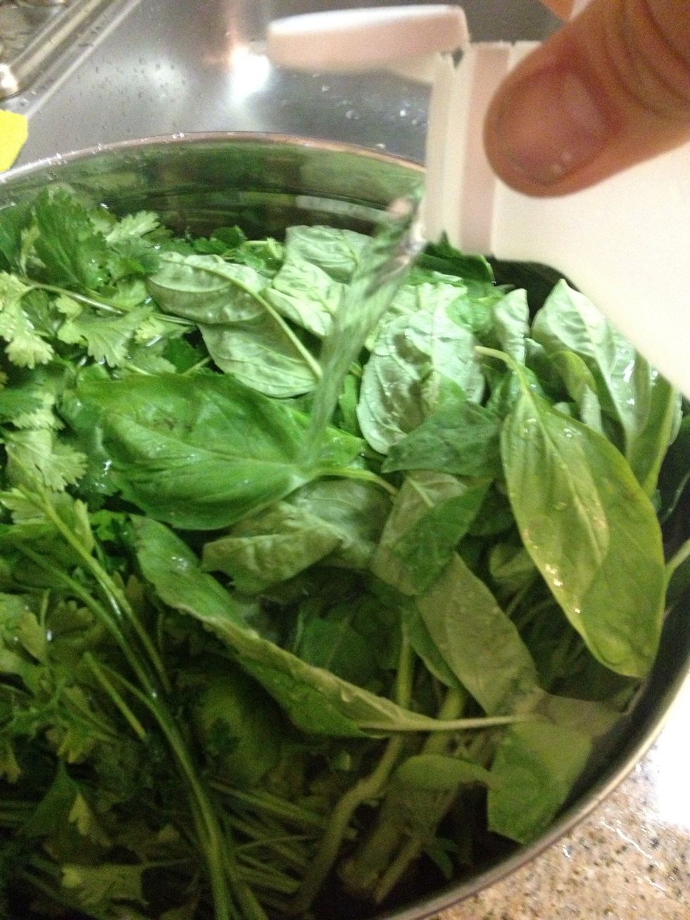 I use 1/4 cup white vinegar to a gallon of water to clean my produce. I soak it for 20 minutes, then rinse and spin dry. Give the tedious task of de stemming all herbs to any willing helpers.