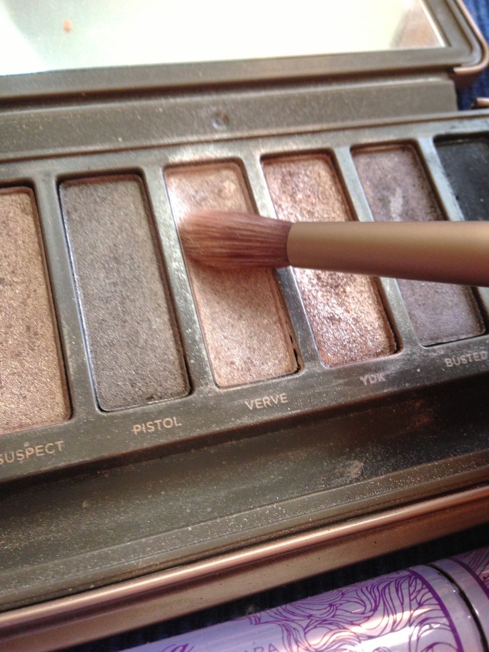 I use a champagne shimmer to soften the crease color, and highlight under my brows.