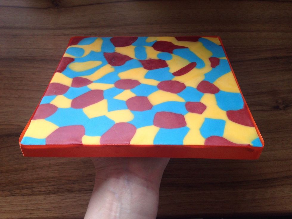 I use a glue stick to attach the ribbon. Make sure the join is at the back of your board when you place the cake on it