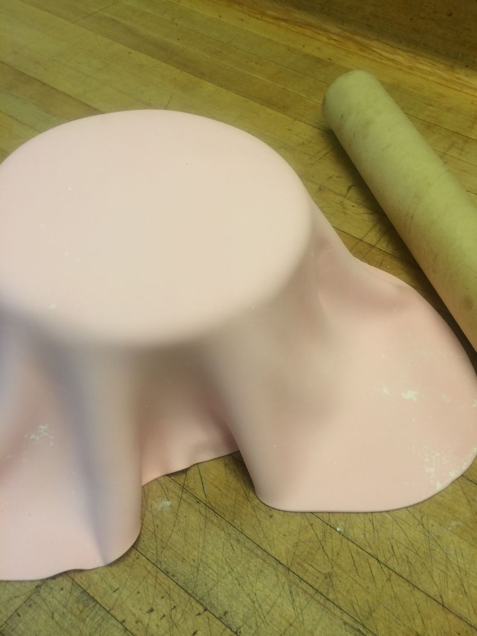 I use a large cardboard tube to roll up and lift the fondant off the work surface and unroll it over the cake.