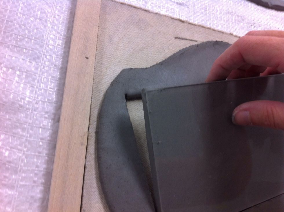 I use a plexiglass template. This holds onto my clay just enough to pull it from the frame easily.