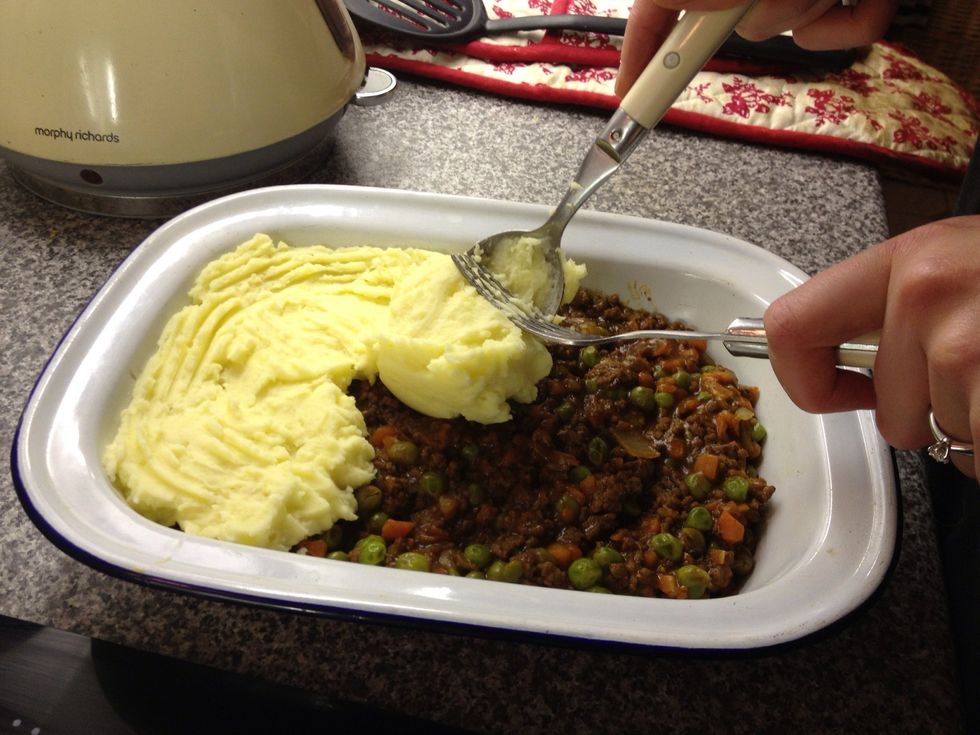 I use a spoon to scoop the potato onto the meat mixture and a fork to decorate!