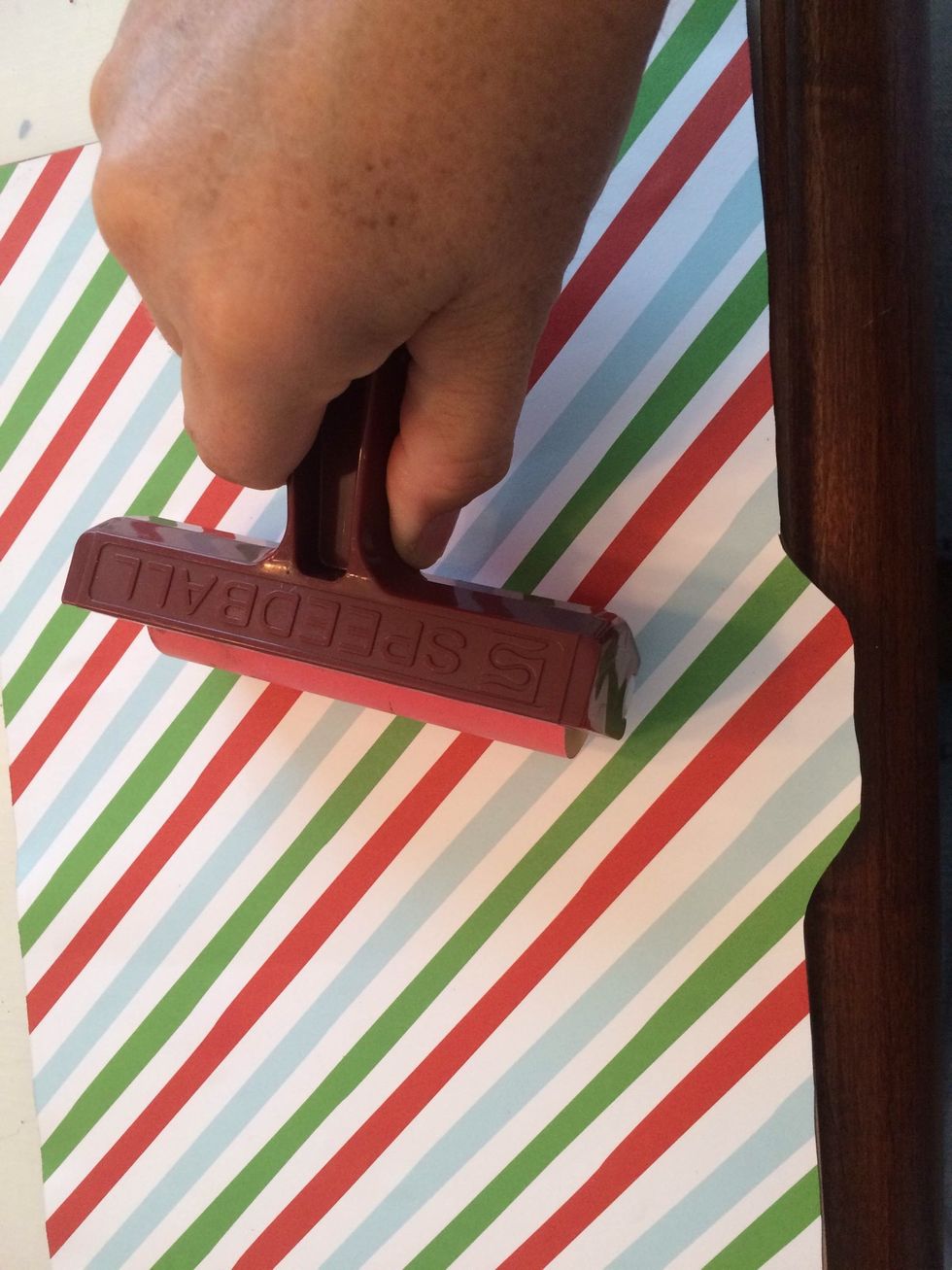 I use bonding memories glue for gluing down the edges. It will not wrinkle your pages. Be sure to put the glue on the edges of your paper especially around the punched holes. Use a brayer to flatten.