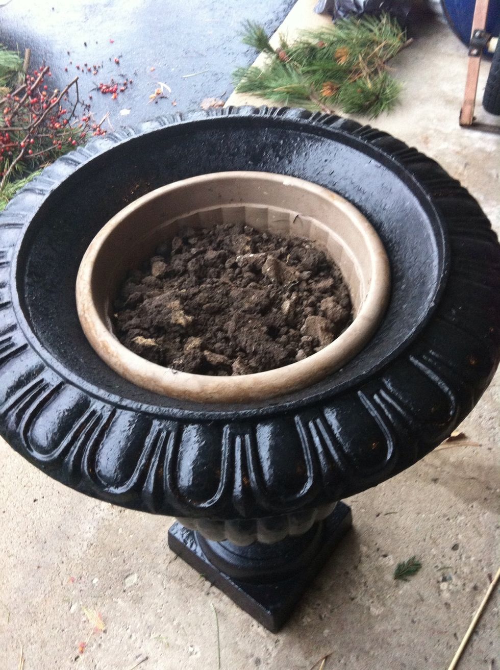 I use leftover soil from the summer pots. Stir it up so its loose.