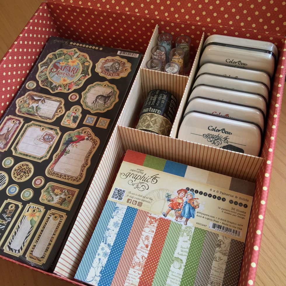 I use my box to store ink pads, embossing powder, paper pads, washi tape and chipboards.