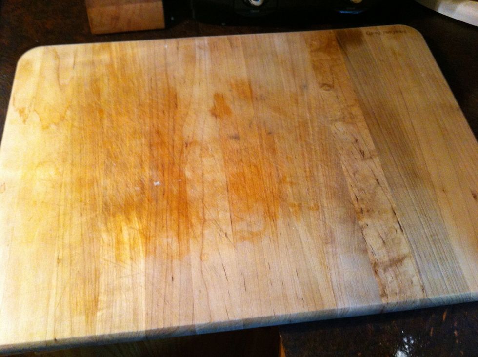 I use my cutting board. Easier to clean. My husband uses wax paper.