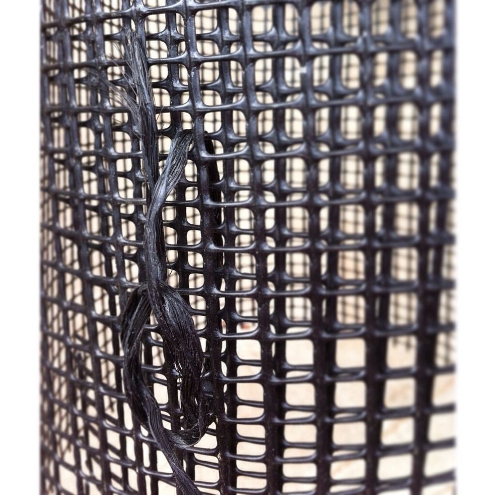 I use small lengths of poly twine to secure the cage. Make sure to weave in and out of both of the overlapped layers. For larger cages, a tie at top and bottom is recommended.