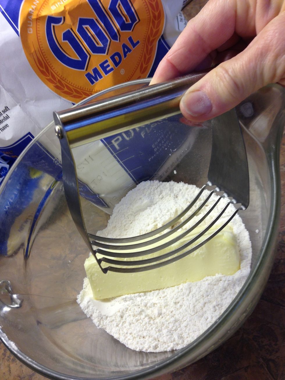 I use this great tool to mix, or "cut in" butter. Two knives work too if you don't have this tool.