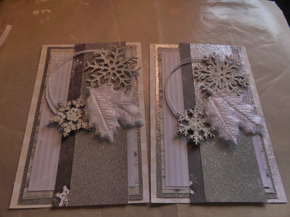 I used 2 white leaves from my stash and attached them between the snowflakes on each card