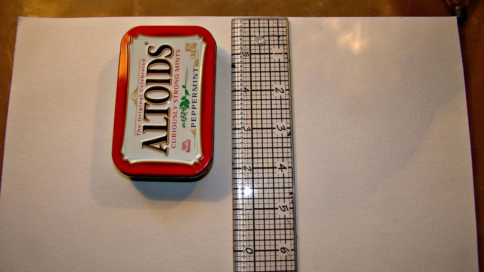 I used a 12 x 12 sheet of cardstock and measured the length of the tin and cut.
