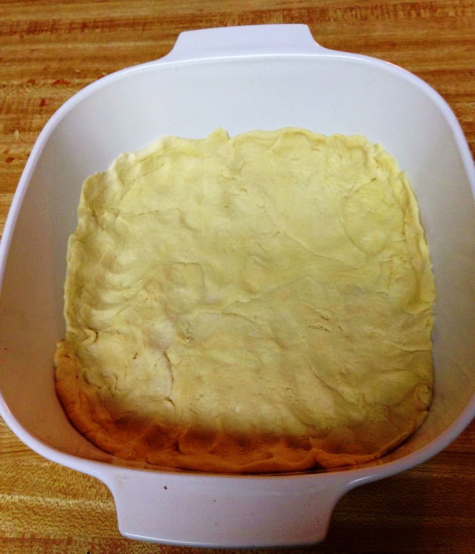 I used a 9x9 for this one because my 9x13 was used. It probably won't be perfect (but nothing in my kitchen ever is ;). ) Press 1 can of the crescent rolls into the bottom, coming about 1/2" up sides