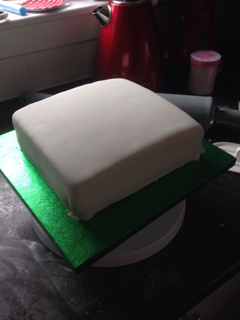 I used a block icing, rolled it out flat and covered the cake