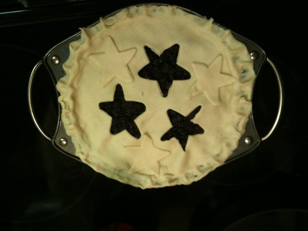 I used a cookie cutter to make vents in top crust but you can also just just slits in it with a knife .Place 2nd crust on top and punch egdes. With a pastry brush add egg wash to top .Bake for 45 mins