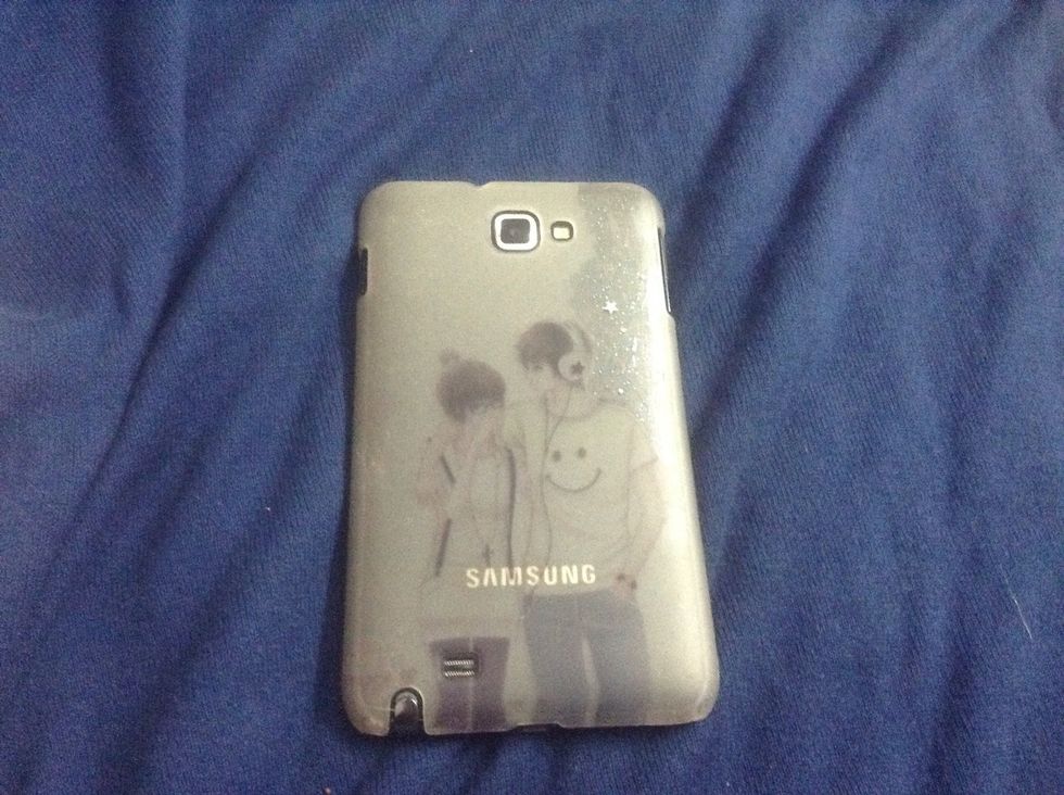 ( I used a cover that has a drawing but it's still see through ) Start painting your cover with your nail polish . I have one with stars and glitter in it so its night sky colour