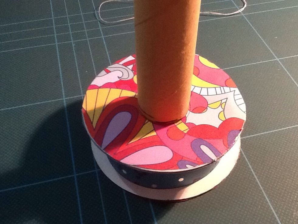 I used a decorated ribbon spool for the base of my mannequin. Trace the circular base of the tube onto the middle of the spool.