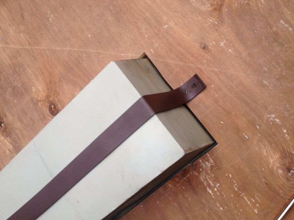 I used a leather strap screwed in to support the weight of the bucket when it's filled