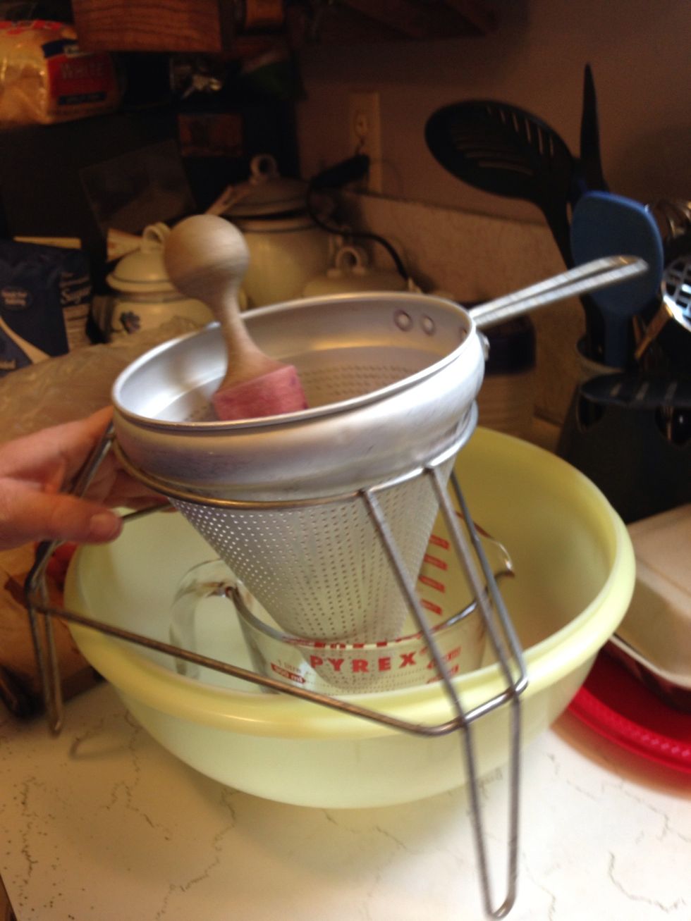 I used a mashing funnel to mash the berries. Jam includes the fruit and the juice of the berries. I used a measuring cup to catch the juice. You need to collect 2 cups of mashed fruit.