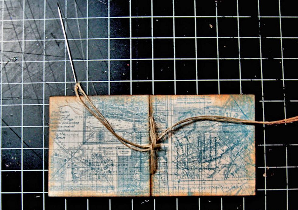 I used a needle and burlap string to stitch my book pages together. The holes are already there, as the die cuts them for you. Just stitch, and then tie a square knot or a bow, whichever you prefer.