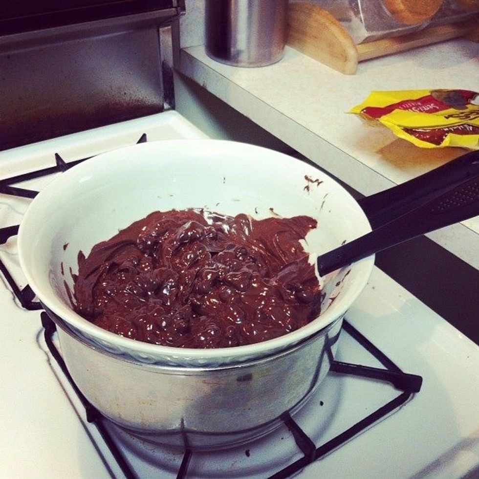 I used a oven safe bowl (as I don't have a double boiler) over a pot. Boil 1 1/2 cup water. Turn the fire off then place the bowl on top of the steaming water. Slowly add & stir the chocolate morsels.