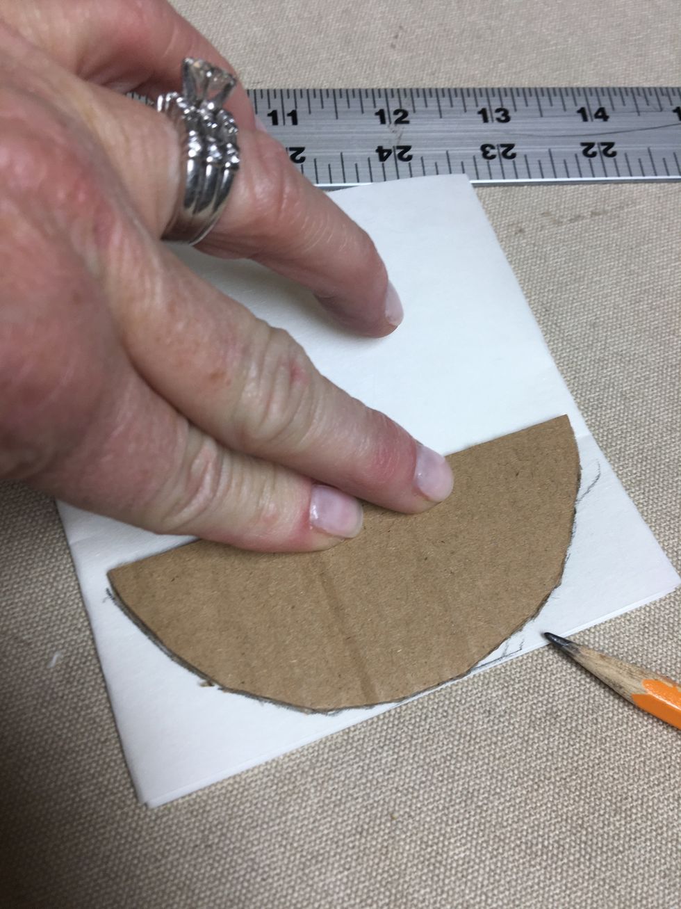 I used a piece of cardboard to determine the shape I wanted then traced it on the bottom of the folded buckram.
