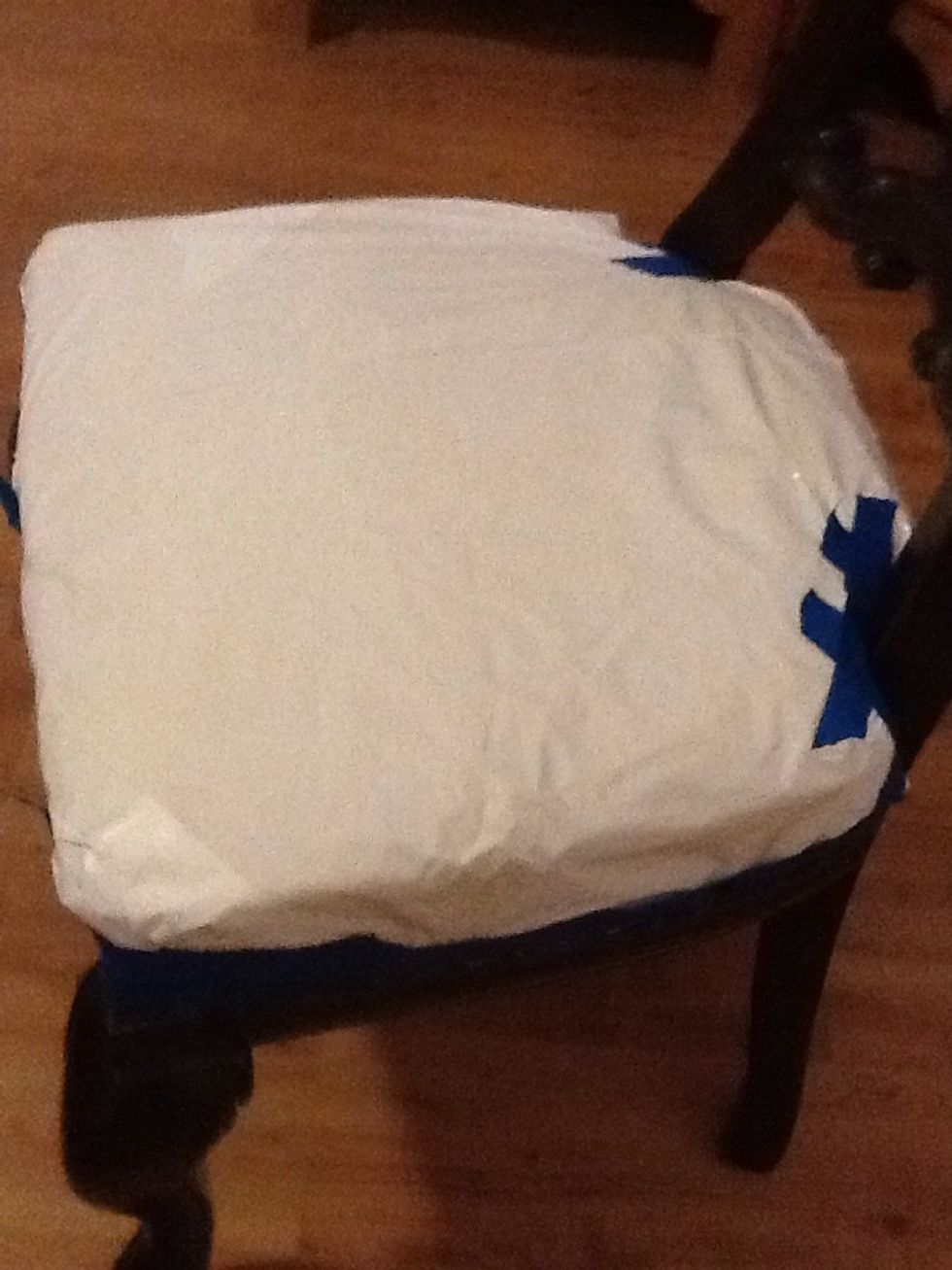 I used a recycled plastic bag to cover the top of the cushion. I just tapped it down and got it ready for the first coat of paint.
