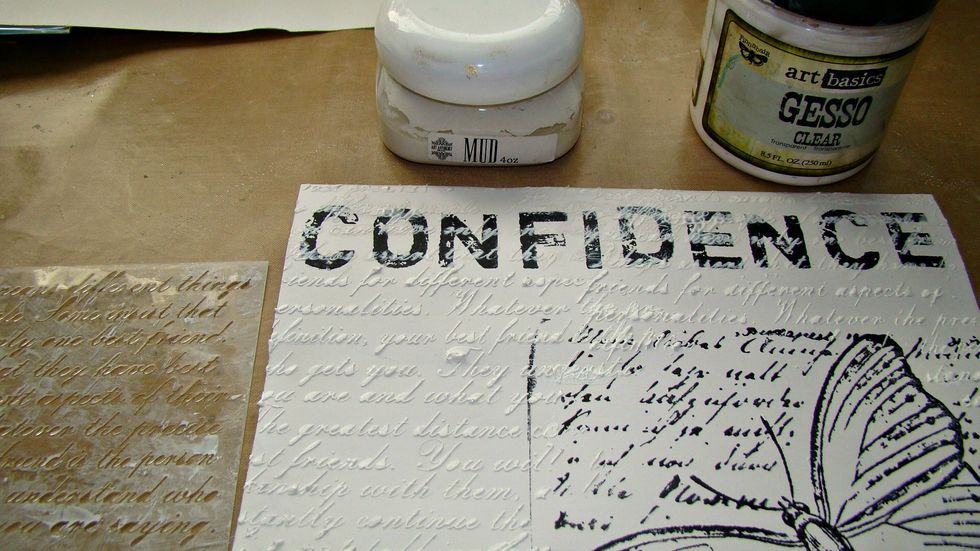 I used a script stencil and over my word I ran clear gesso, so it added the texture of the stencil but didn't take away from my title. Used Mud Paste for the rest of the page. Comment