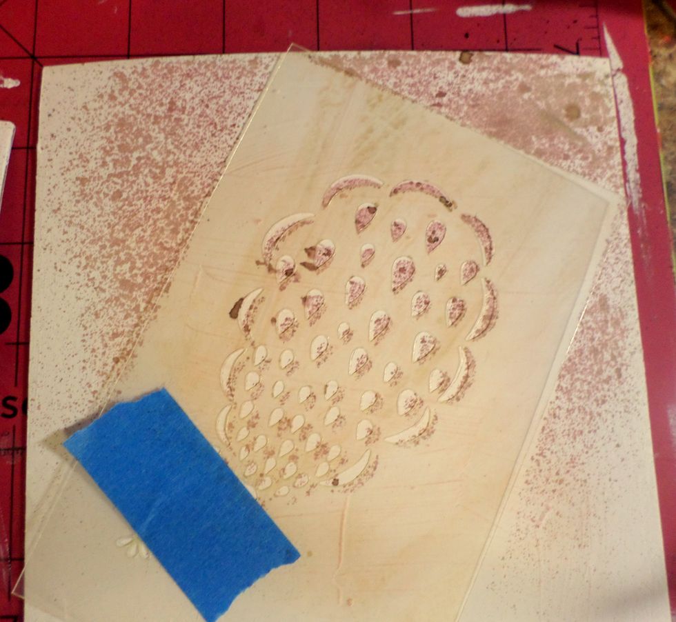 I used a stencil from SinCity Stamps and spray ink for the next layer. Let dry.