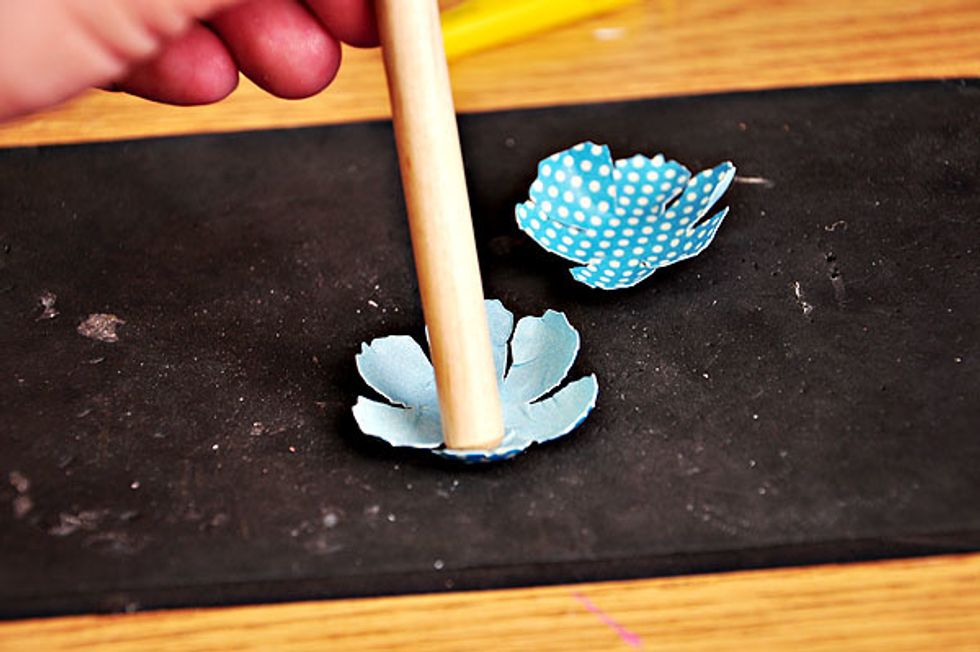 I used an embossing tool to curl my die cut flowers. Spritz on a bit of water first on the flowers before doing this, to easily manipulate the shape you want to achieve.