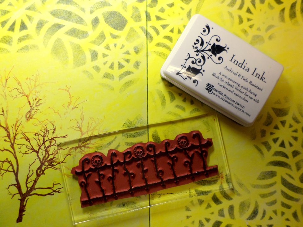 I used black ink with this fence stamp from SinCity Stamps across the bottom of the pages.