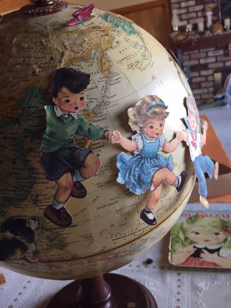 I used double sided tape to place pictures around globe to see where they looked best.