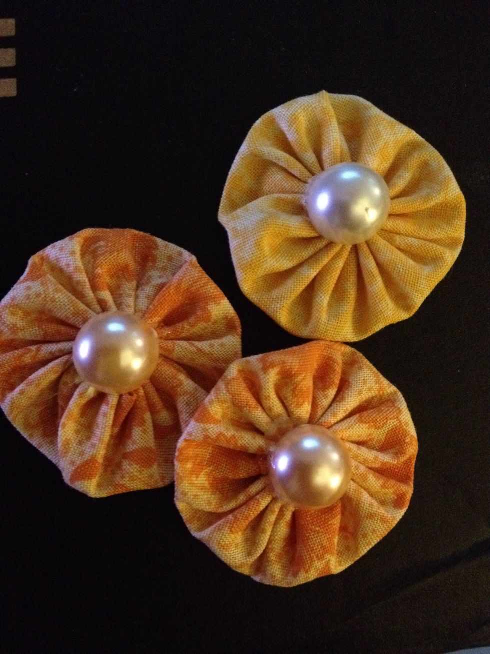 I used pearl brads and hot glued it to the center.