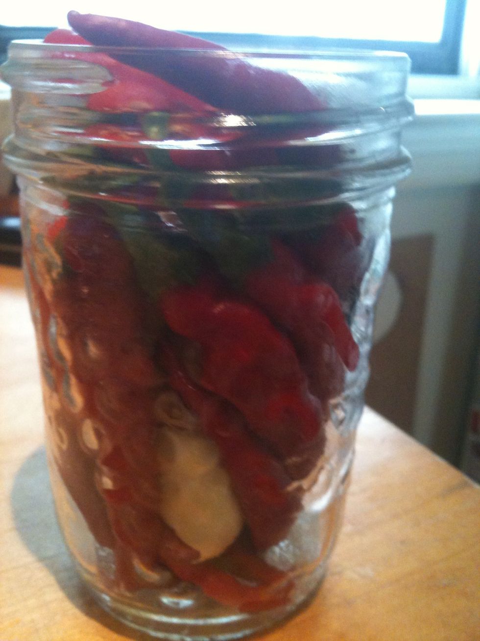 I used peeled garlic and left the peppers whole. Stems are okay to leave on or take off, your choice. The more you pack in can result in a thicker sauce.