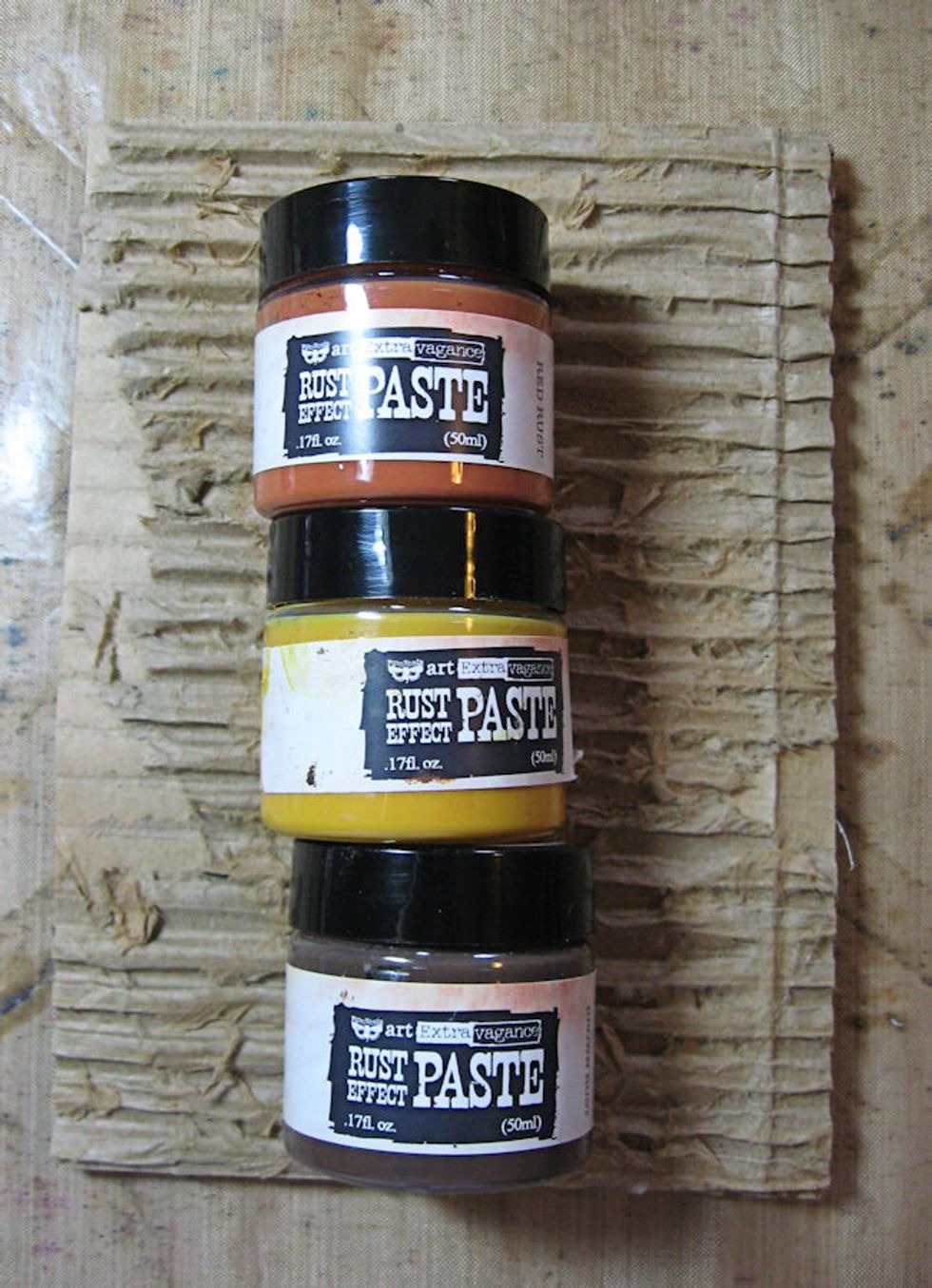 I used Prima Rust paste to give my corrugate panels an aged, rusty look.  But you could paint or use gelatoes or Distress Crayons just as easily.  I just like the texture and grunge of rust paste.
