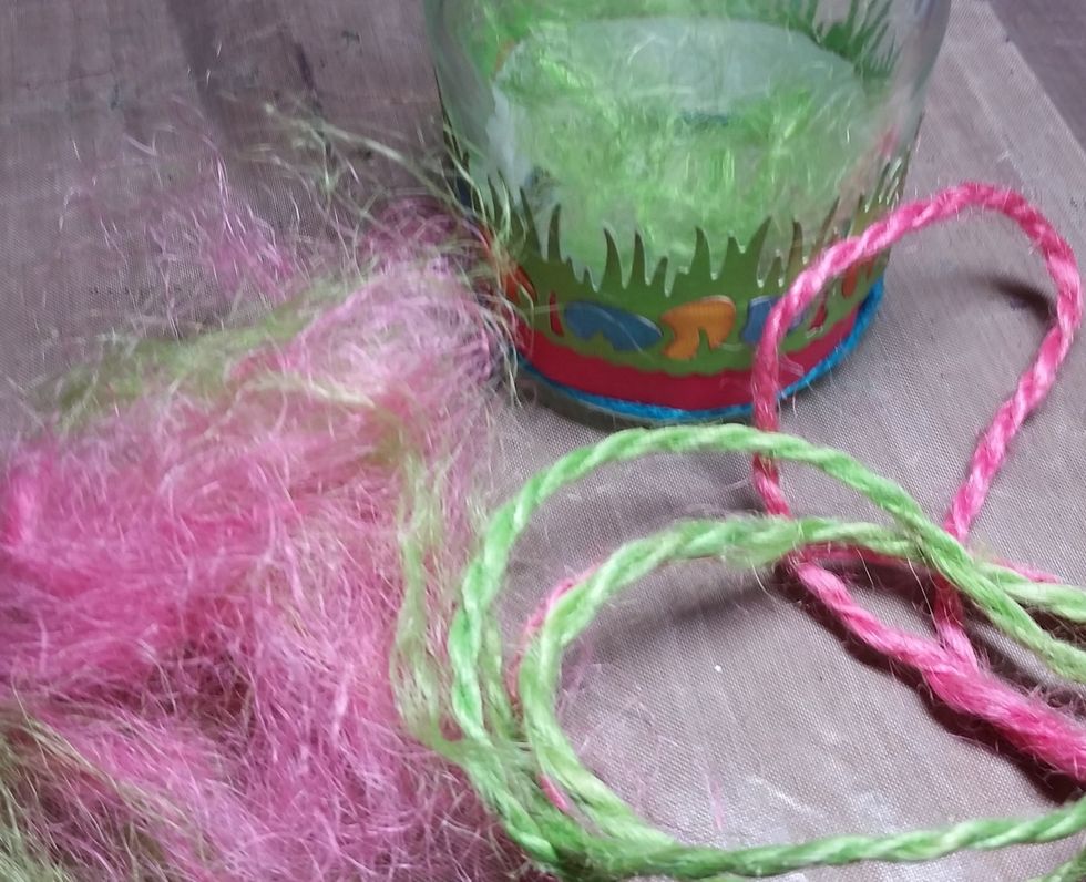 I used sections of the green and pink rope pulled apart as "grass" inside the jar.